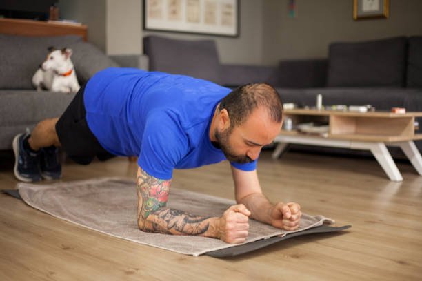 Man working out at home in a plank position