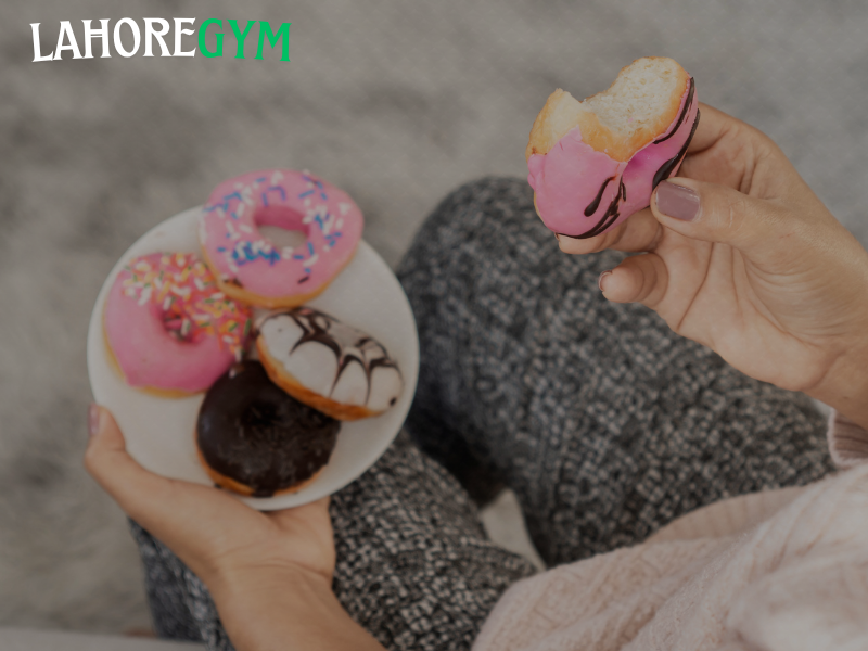 Post-workout sugar consumption – does it help or hurt? man eating banana after workout inside gym to recover energy